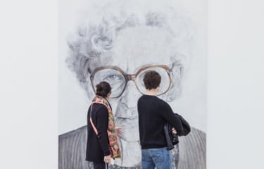 people standing in front of a painting